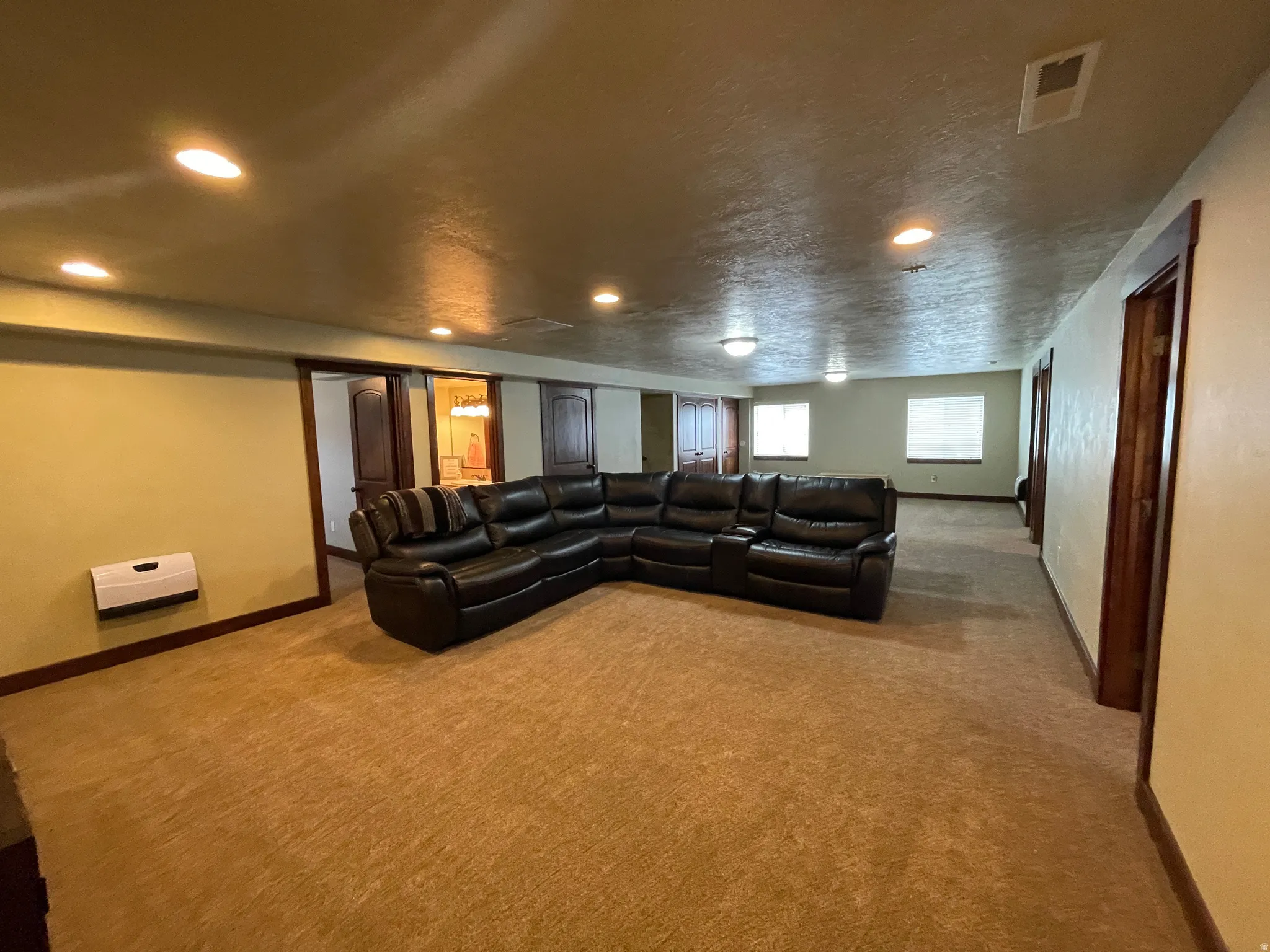Carpeted home theater room featuring baseboards and recessed lighting
