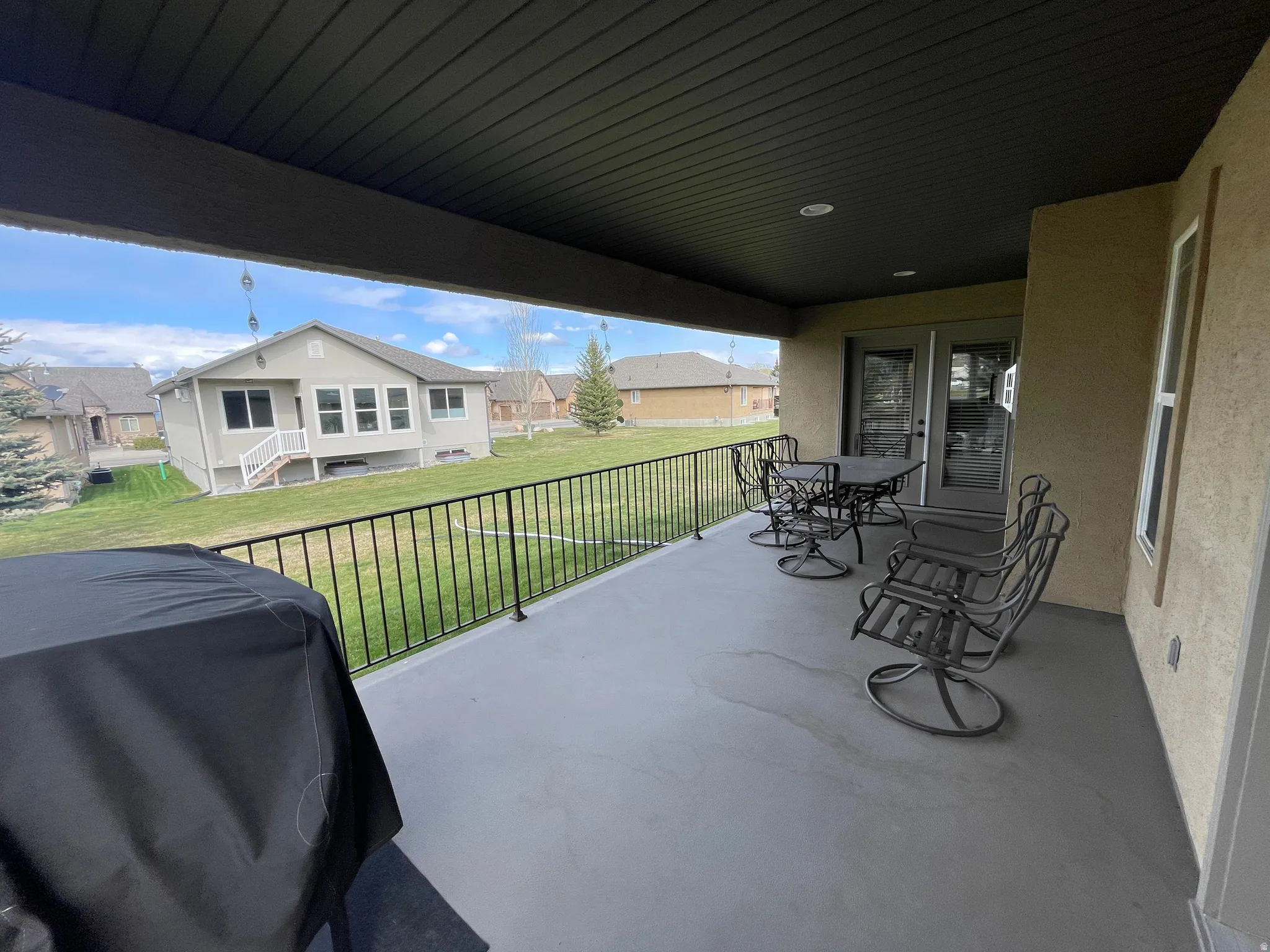 View of patio / terrace with outdoor dining space, grilling area, and a residential view