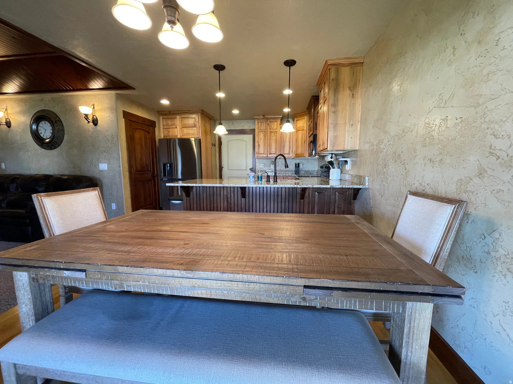 Dining area featuring a textured wall and baseboards