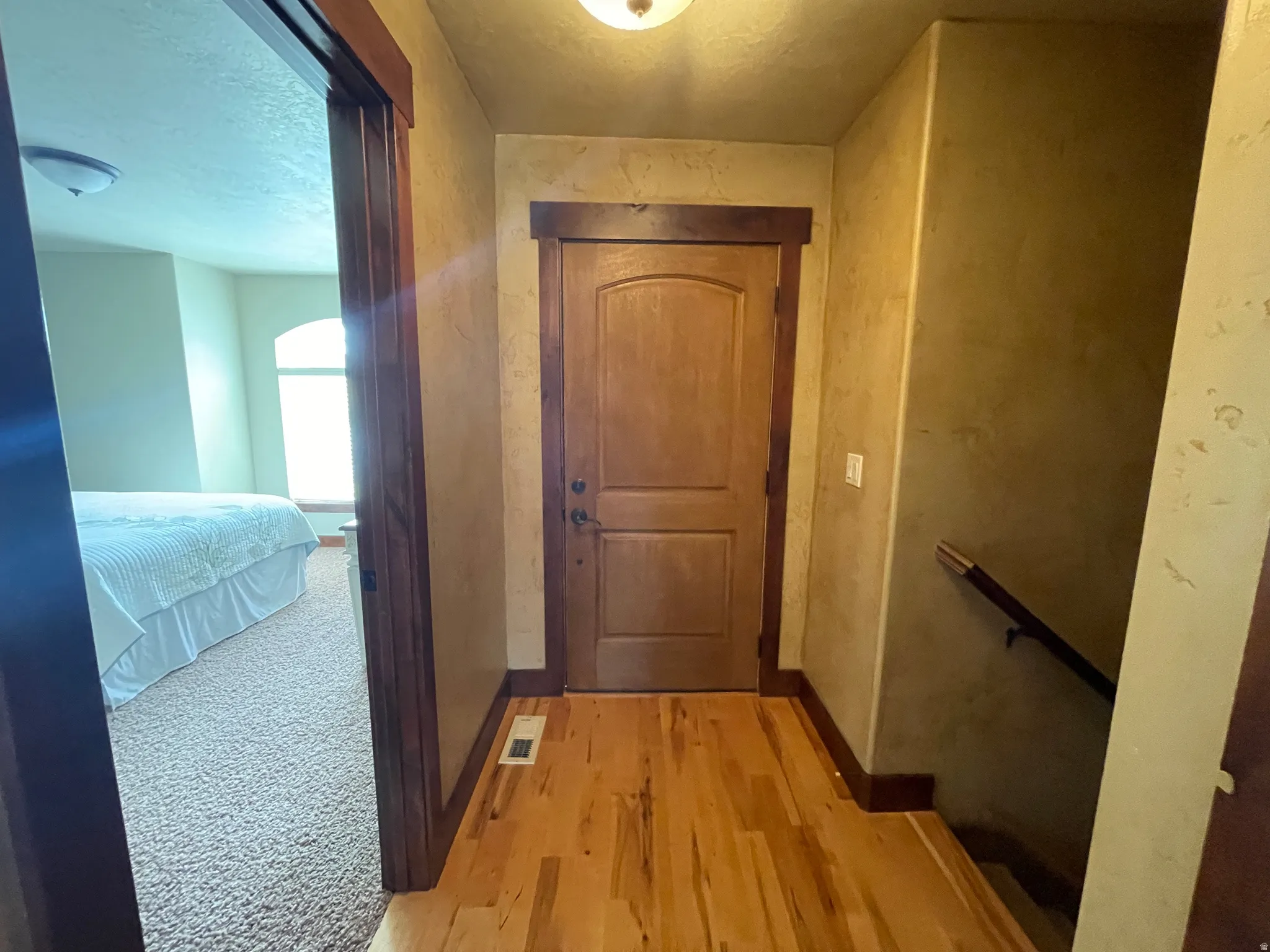 Hallway with baseboards and light wood-style floors