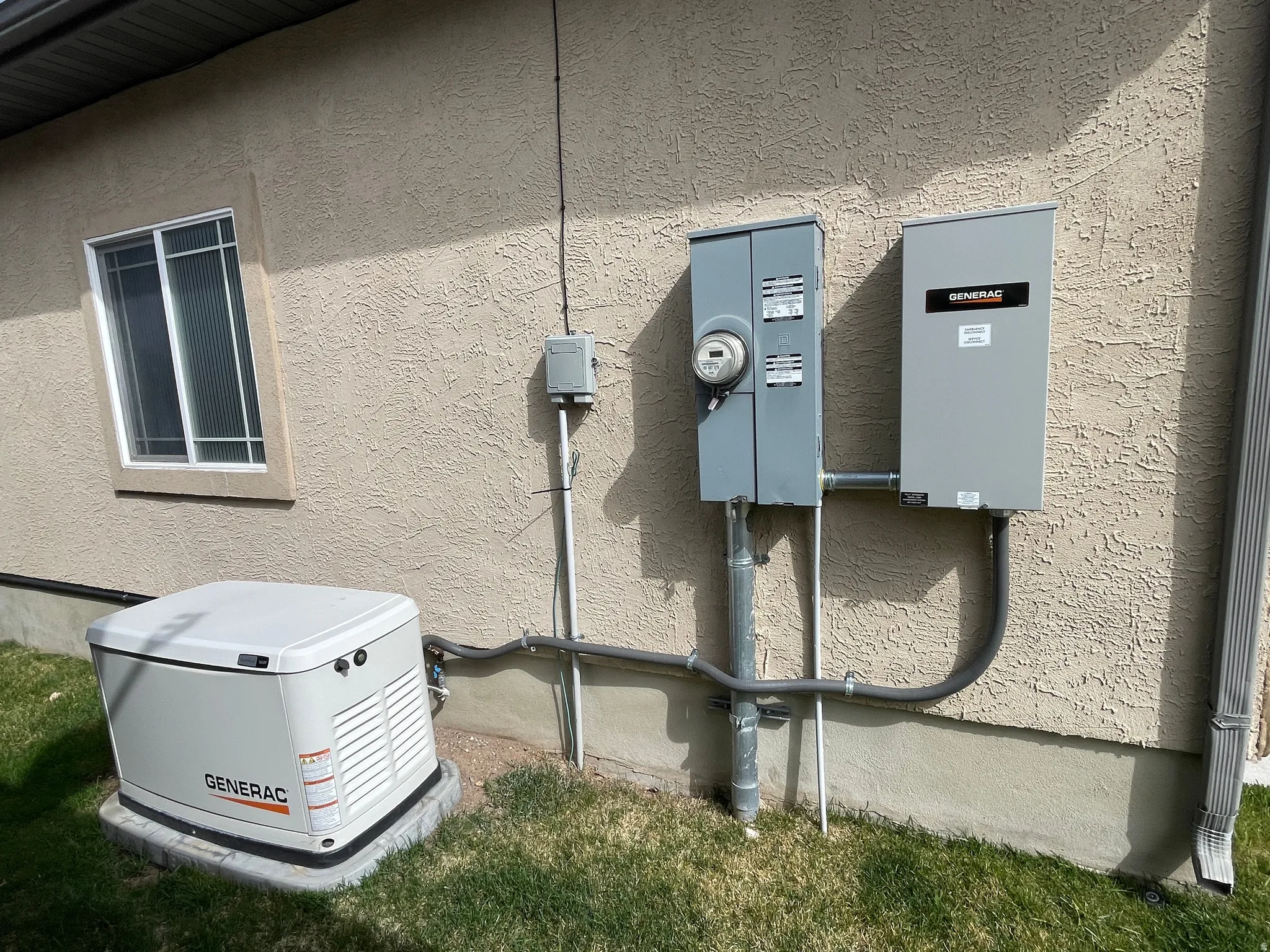 Exterior view of stucco siding and electric meter