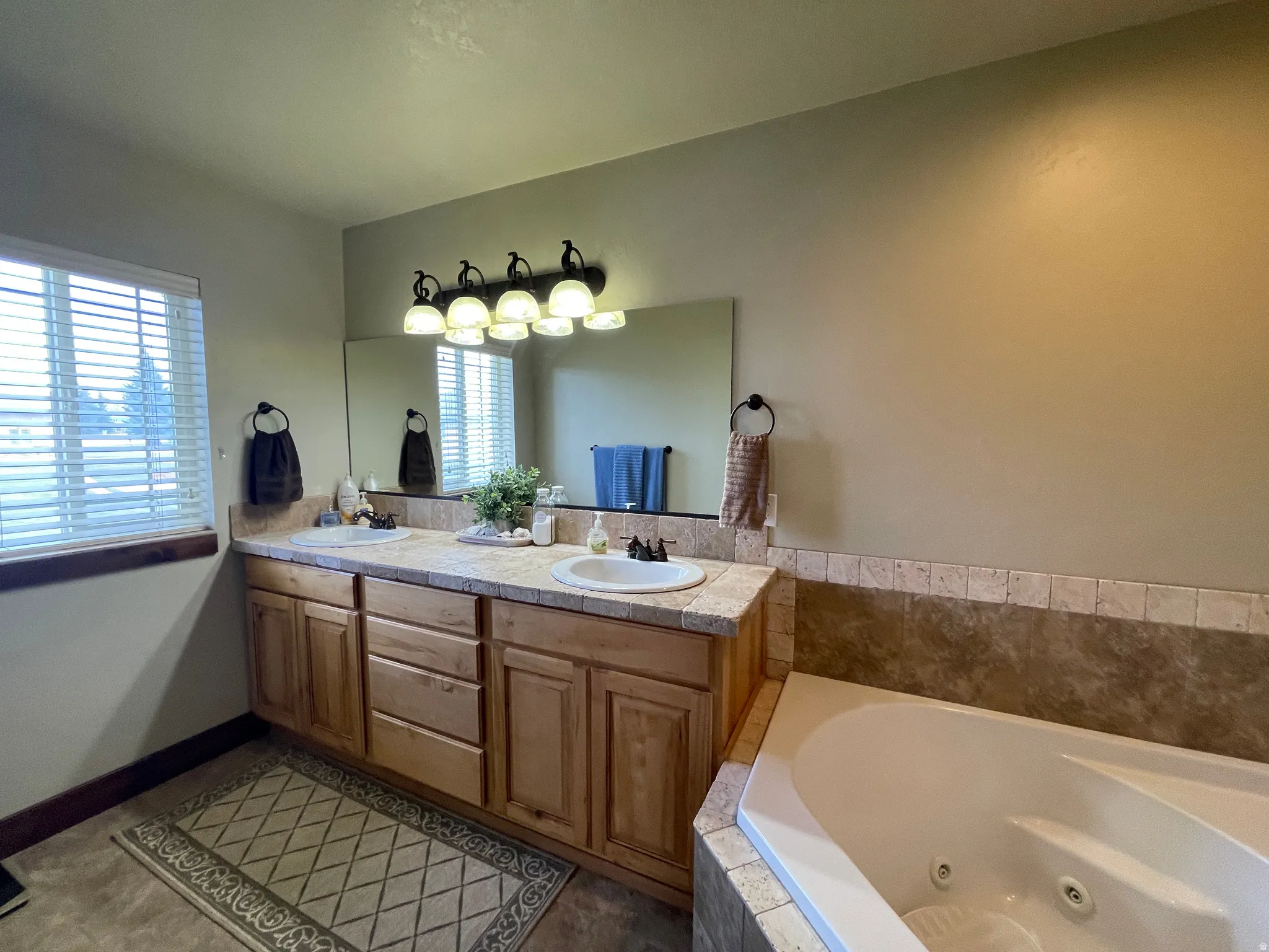 Full bathroom featuring double vanity and a whirlpool tub