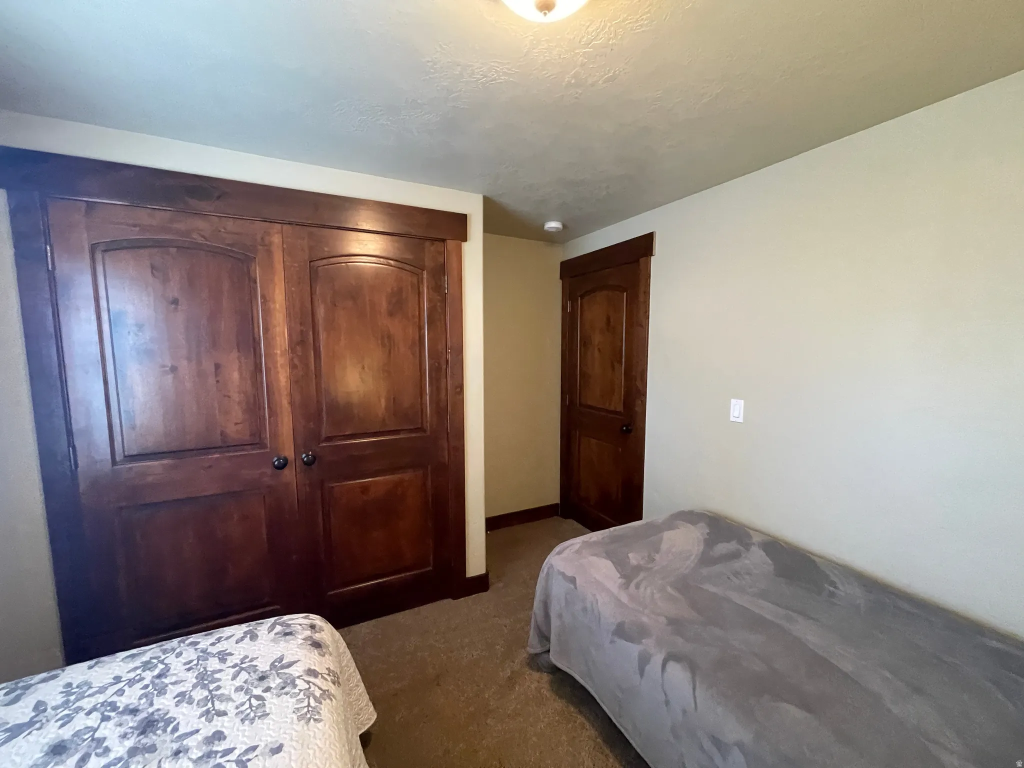 Bedroom featuring a closet and dark carpet