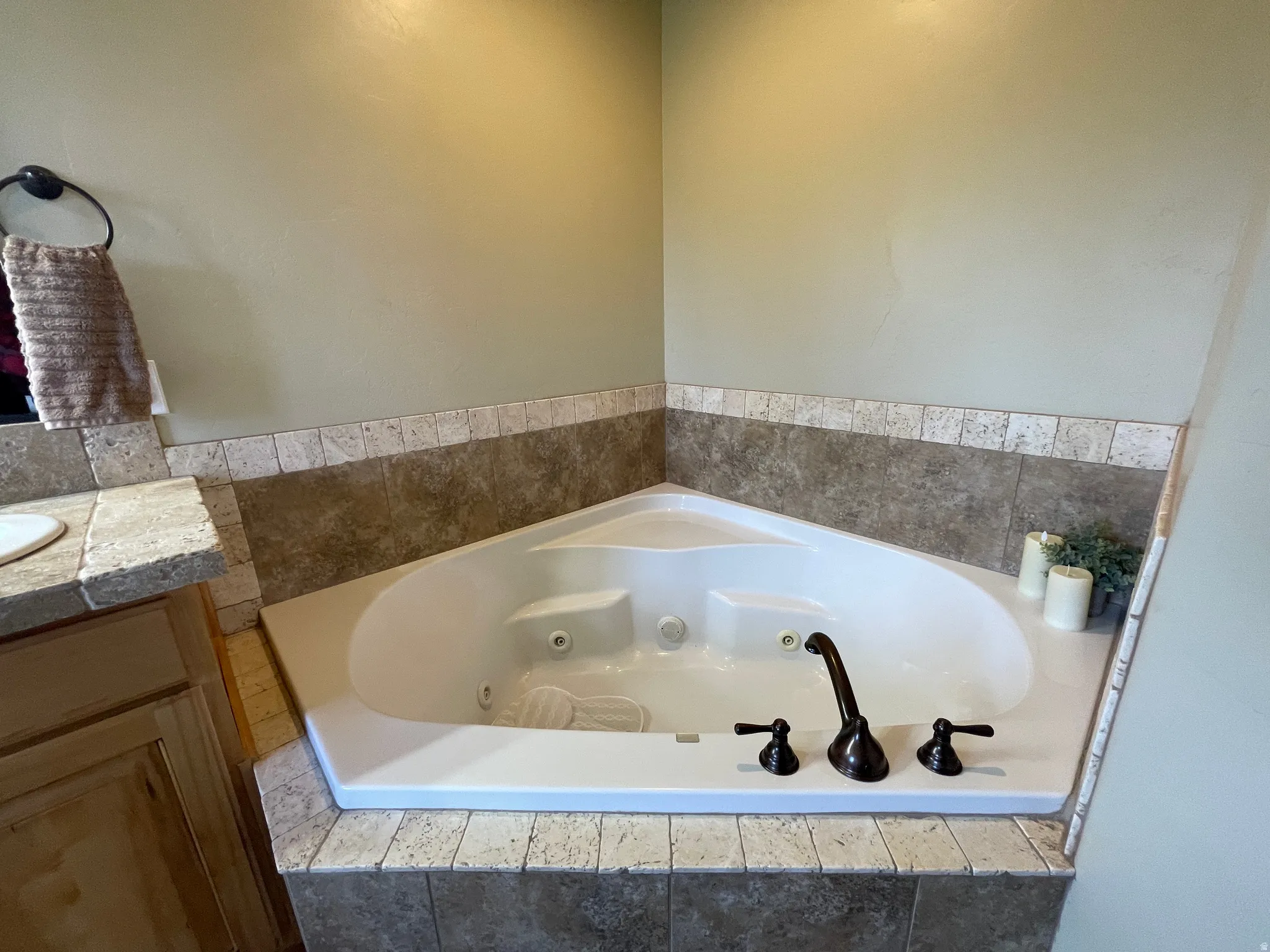 Full bathroom with vanity and a jetted tub