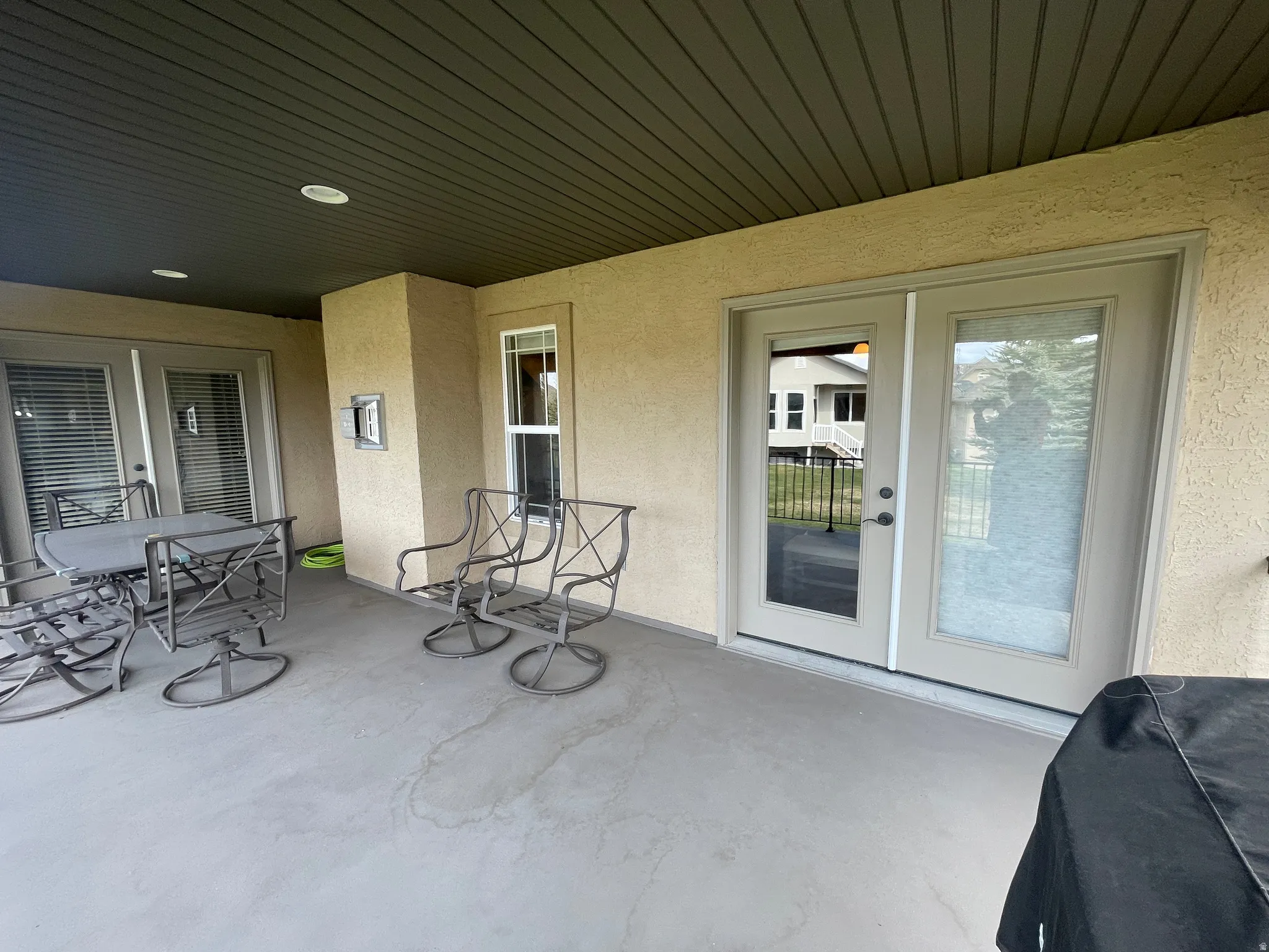 View of patio with outdoor dining space and french doors