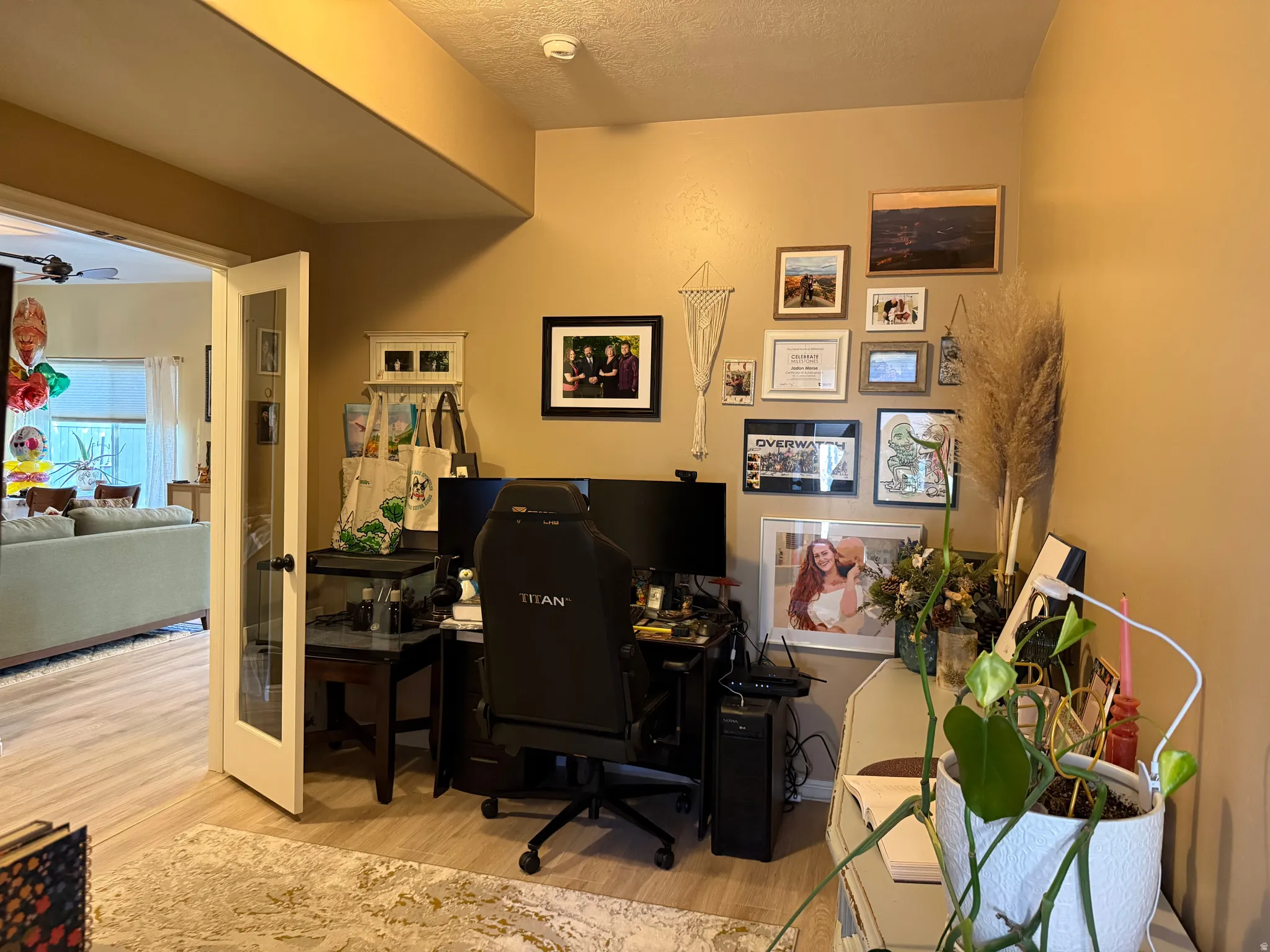 Home office featuring light wood finished floors and a textured ceiling