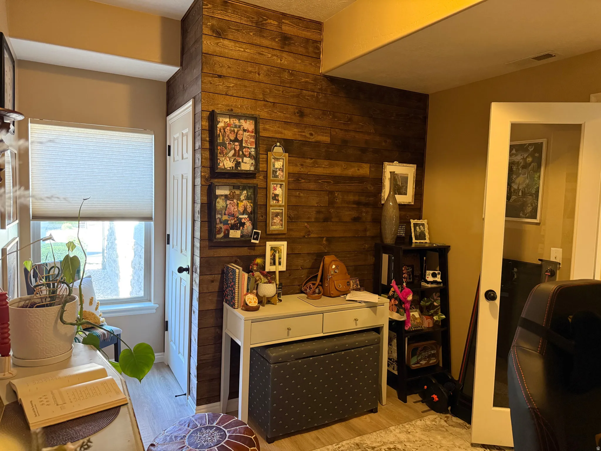 Interior space with wood walls and light wood-style flooring