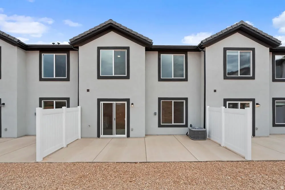 Rear view of property with stucco siding and a tile roof