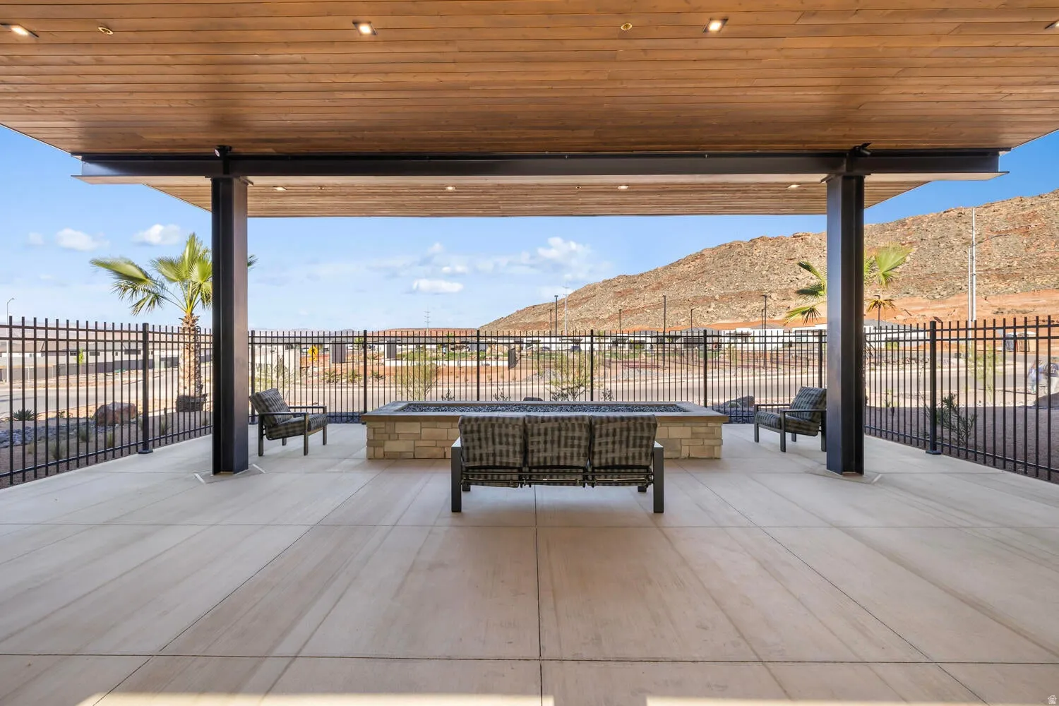 Fenced backyard with a fire pit, a patio, and a mountain view
