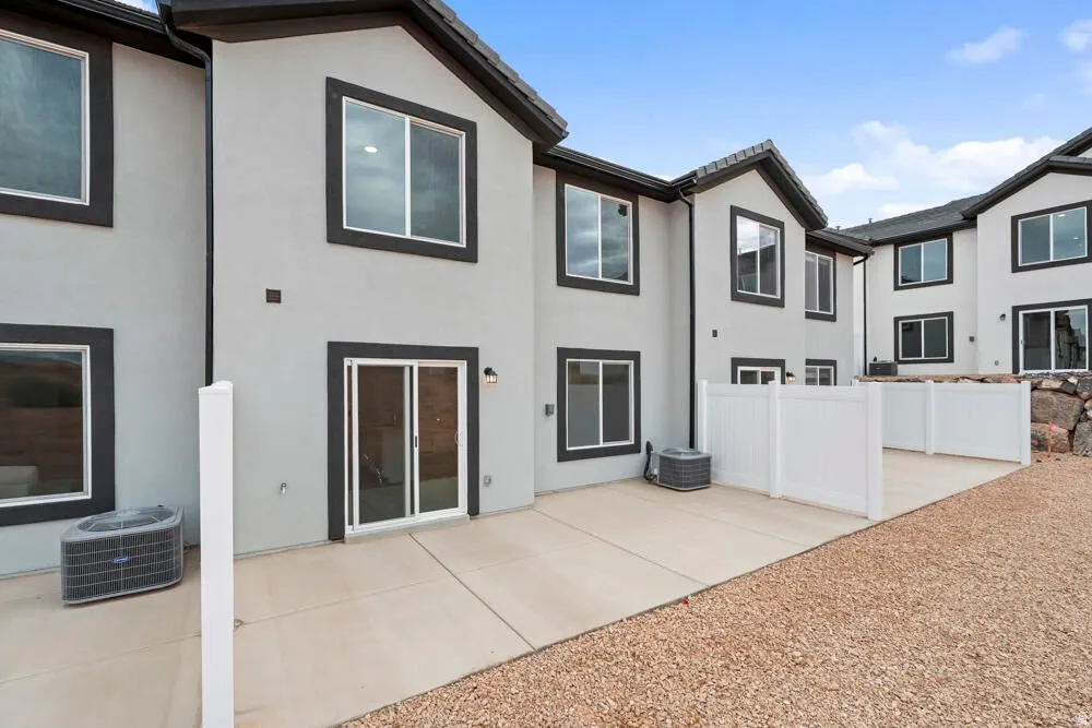 Rear view of house featuring stucco siding and a patio