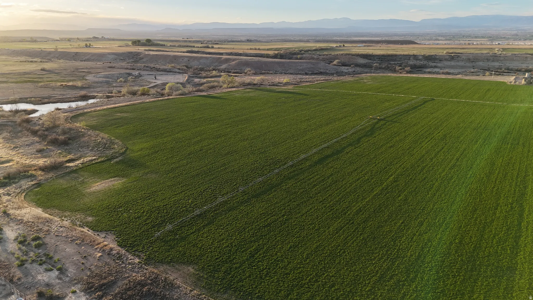 Overview of rural landscape with mountains and rows of crops