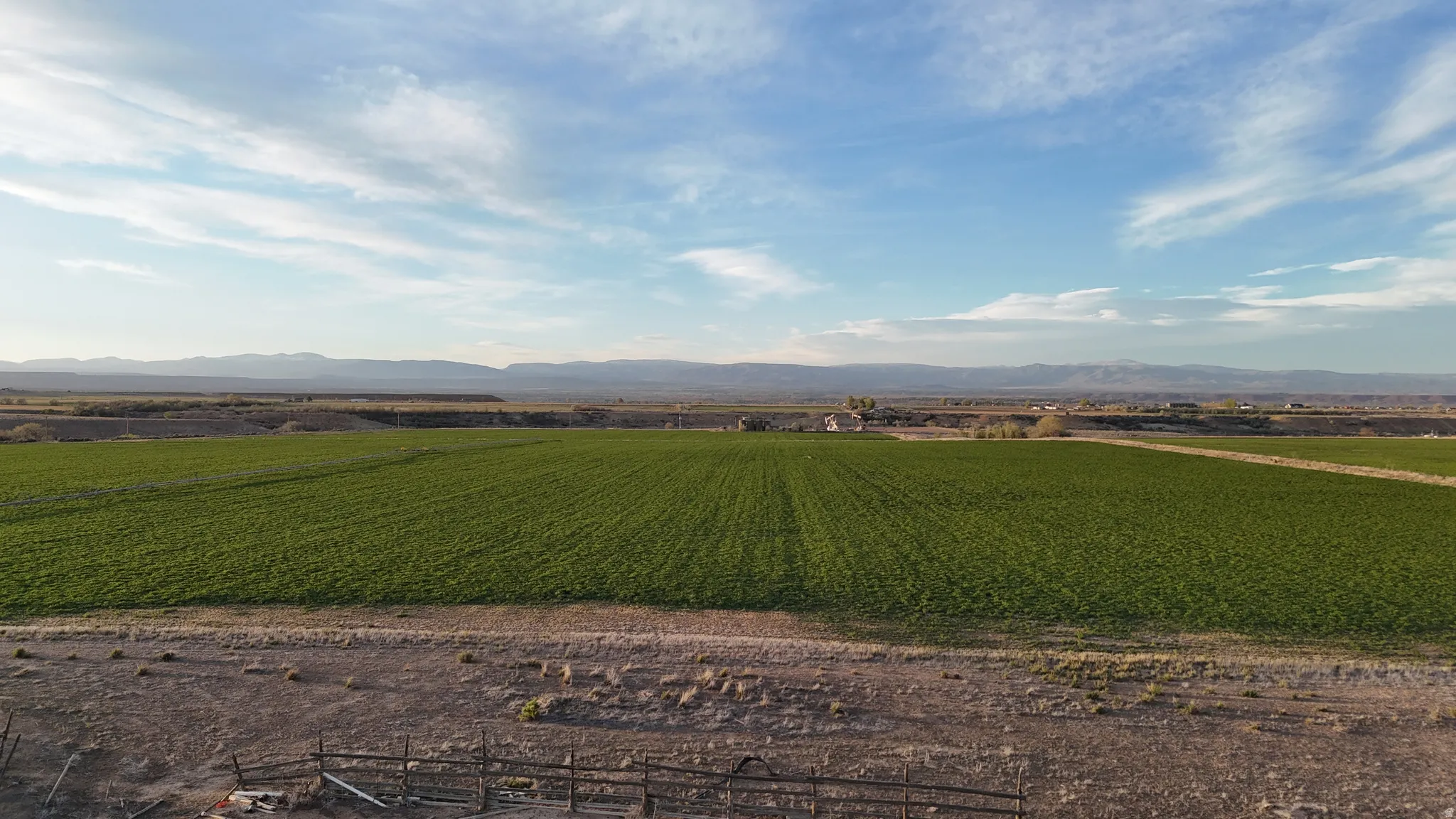 View of mountain background featuring large plots for crops and rural landscape