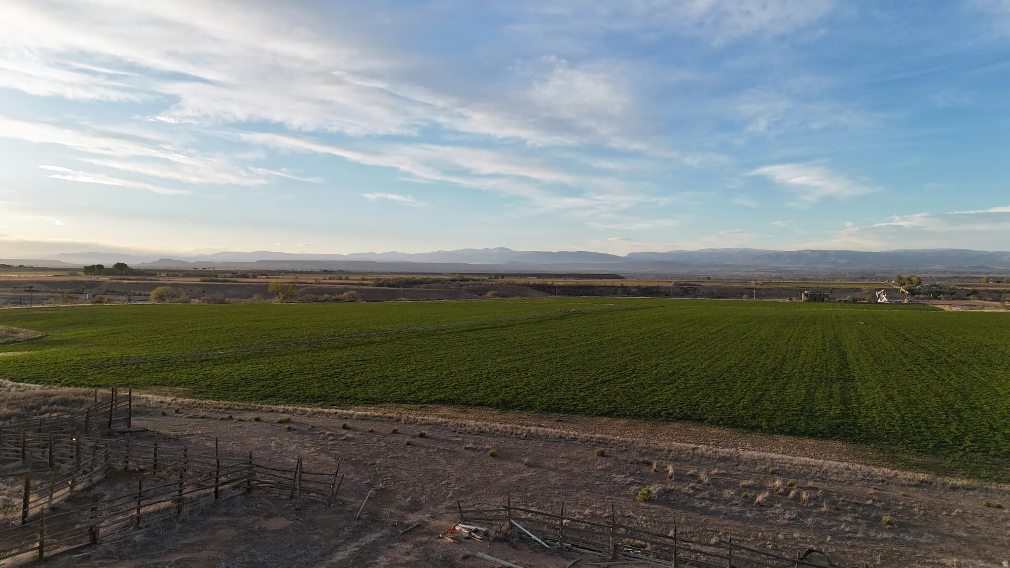 View of mountain background featuring farmland and rural landscape