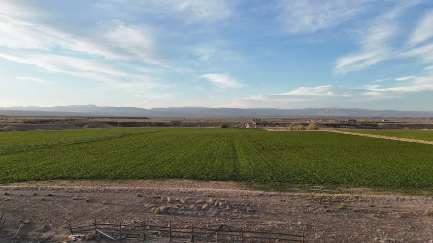 View of mountain background featuring large plots for crops and rural landscape