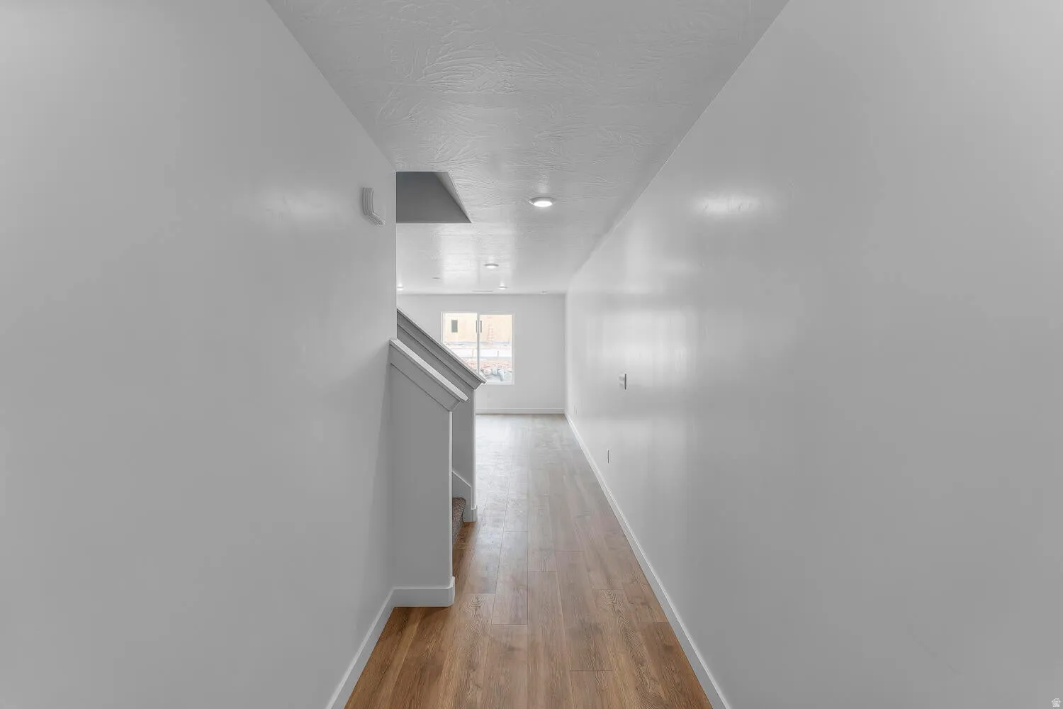 Corridor with baseboards and dark wood-type flooring