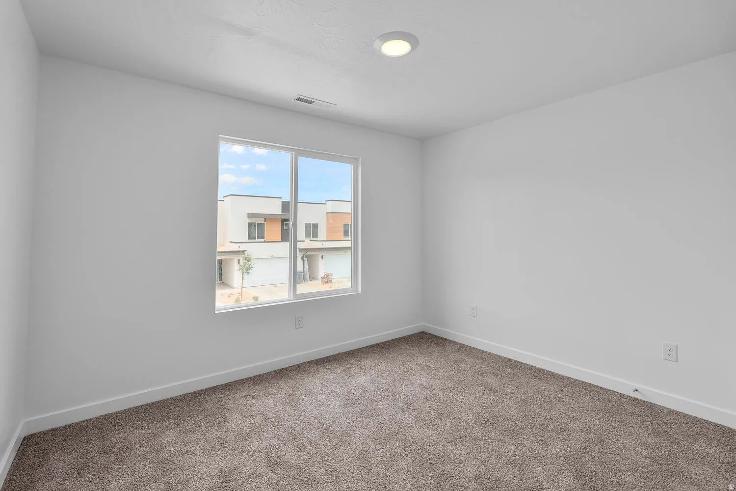 Unfurnished room featuring baseboards and carpet flooring