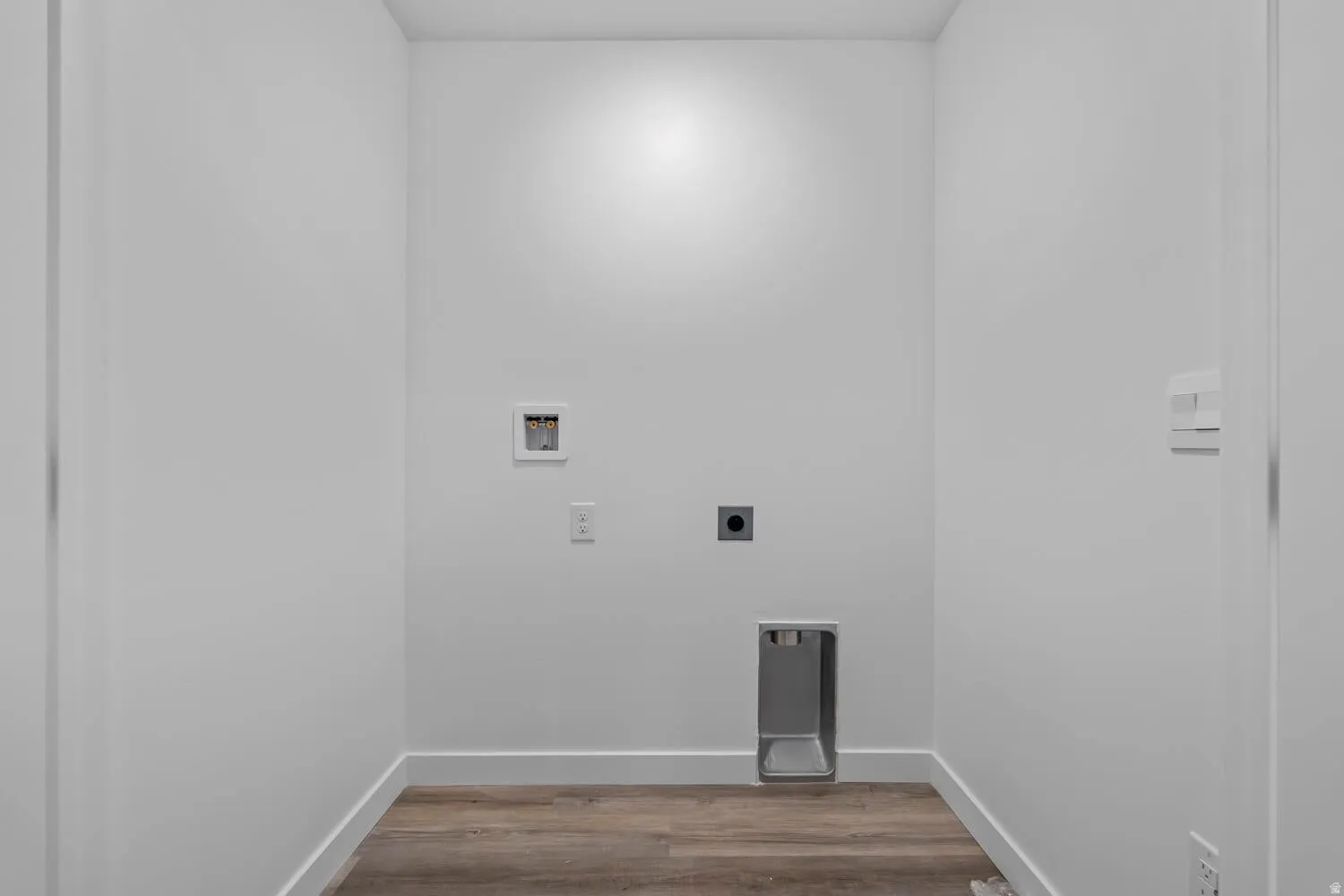 Laundry room with light wood finished floors, washer hookup, and hookup for an electric dryer