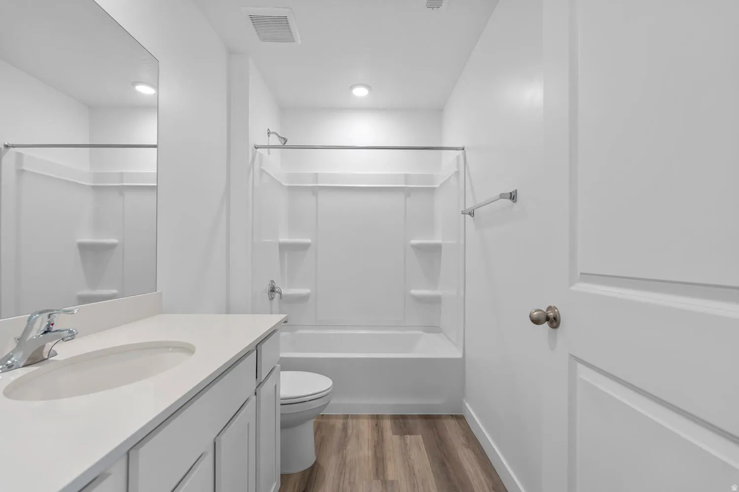 Bathroom featuring vanity, light wood finished floors, and shower / tub combination