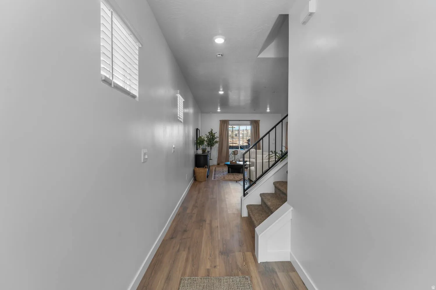Hallway featuring stairway and dark wood-style flooring
