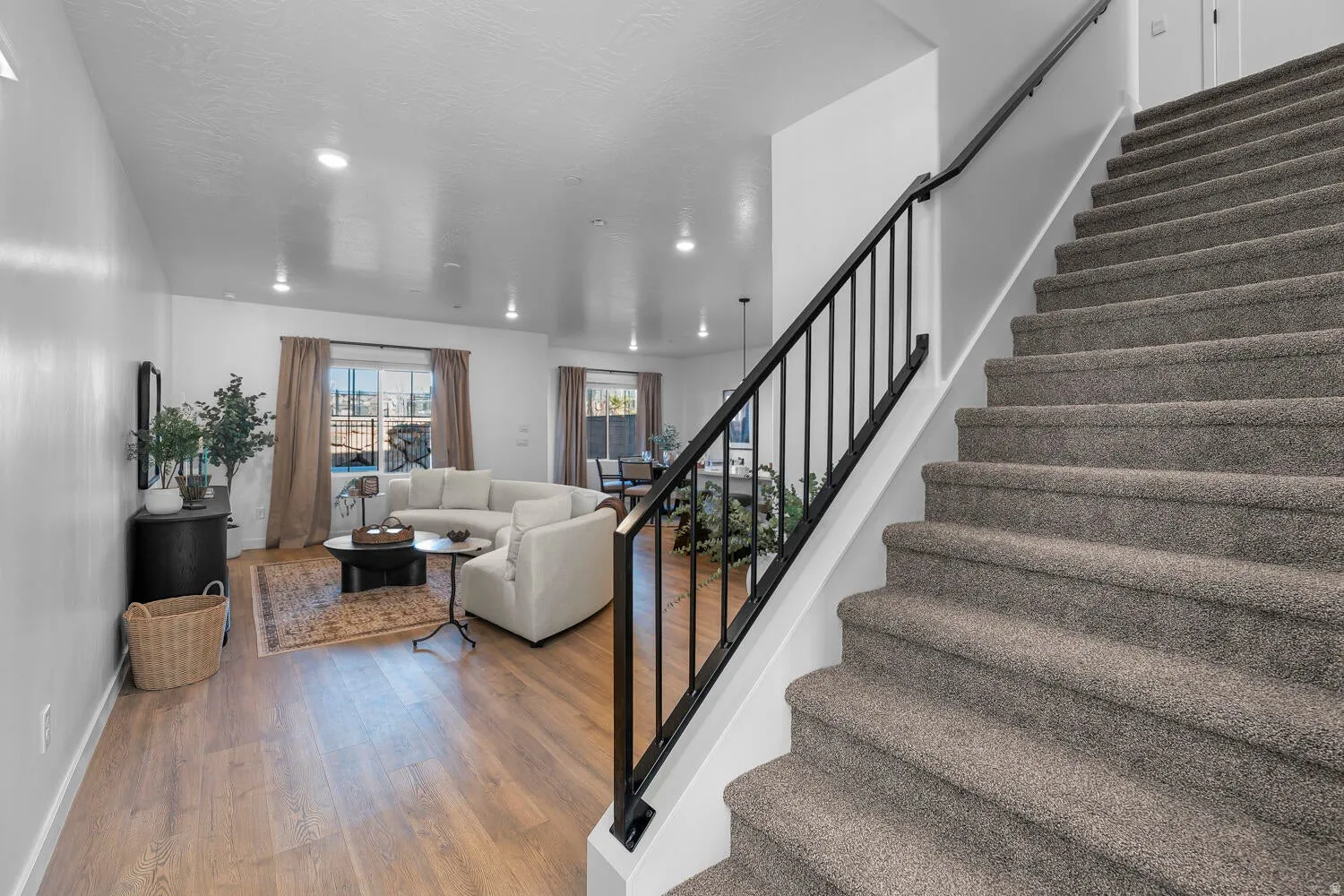 Stairs featuring wood finished floors and recessed lighting