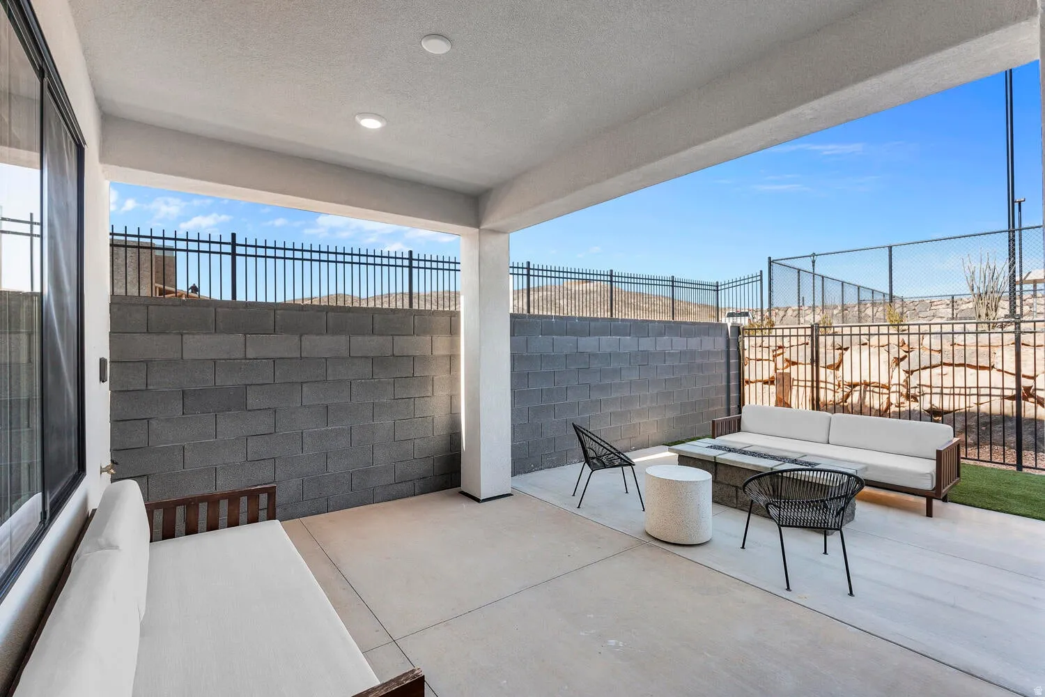Fenced backyard with a patio and an outdoor living space