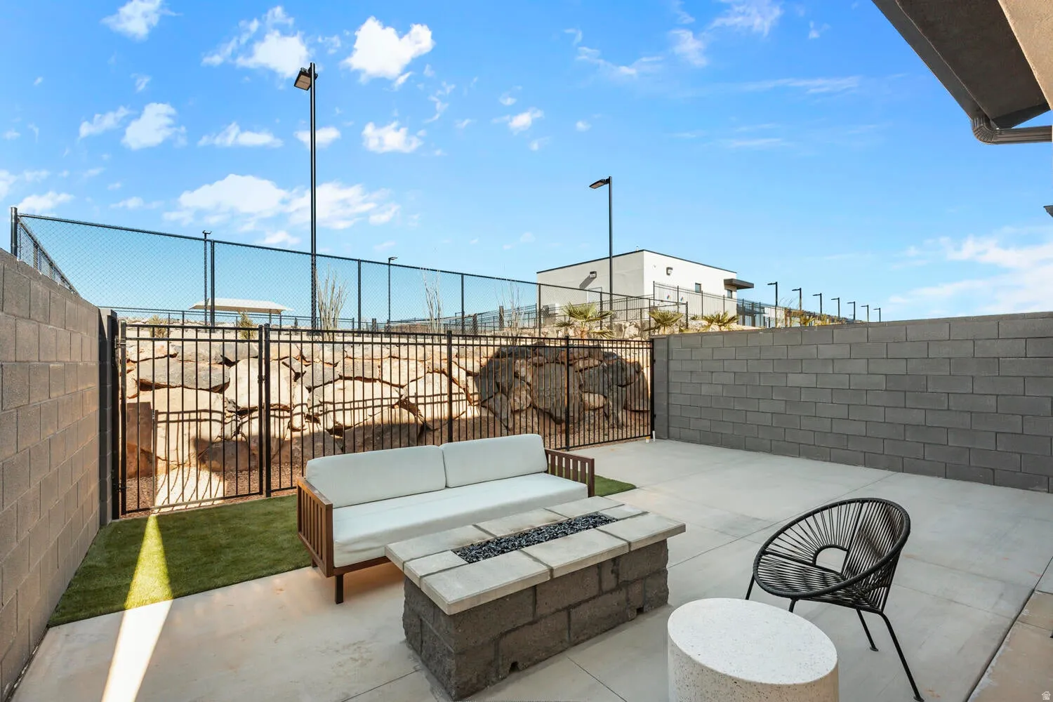 Fenced backyard with an outdoor fire pit and a patio