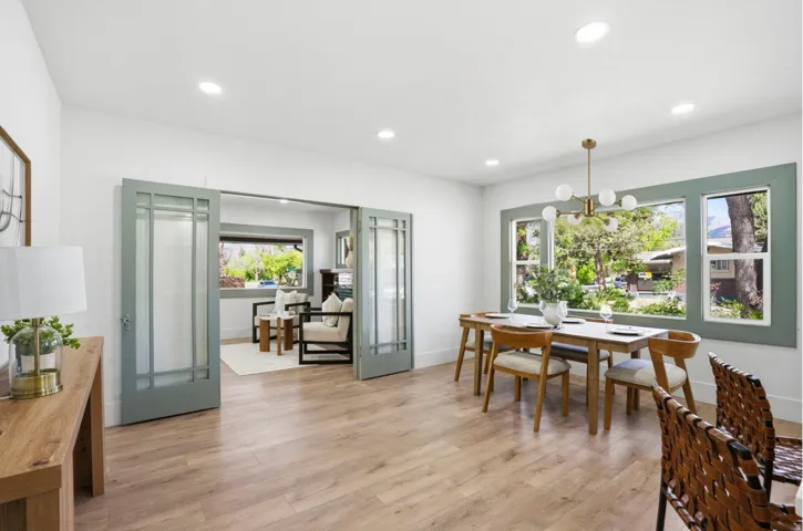 Dining area featuring wood-finish flooring, recessed lighting, and a modern chandelier