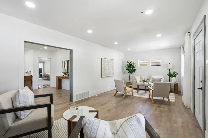 Living area with hardwood / wood-style flooring and recessed lighting