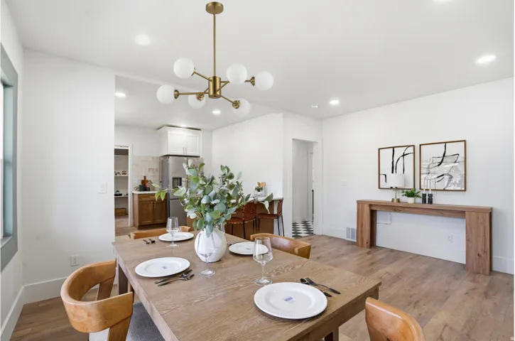 Dining area featuring a modern brass chandelier with globe lights, recessed lighting, and wood-finish flooring