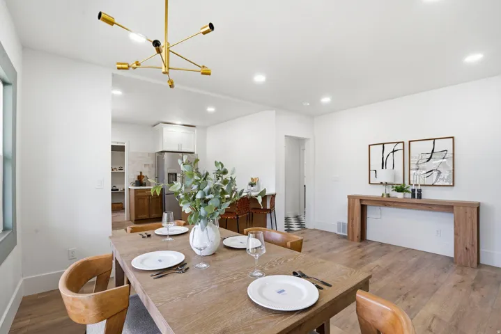 Dining room with light wood-style floors and a chandelier