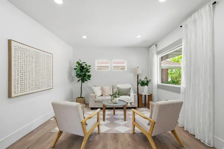 Living area with wood finished floors, plenty of natural light, and recessed lighting