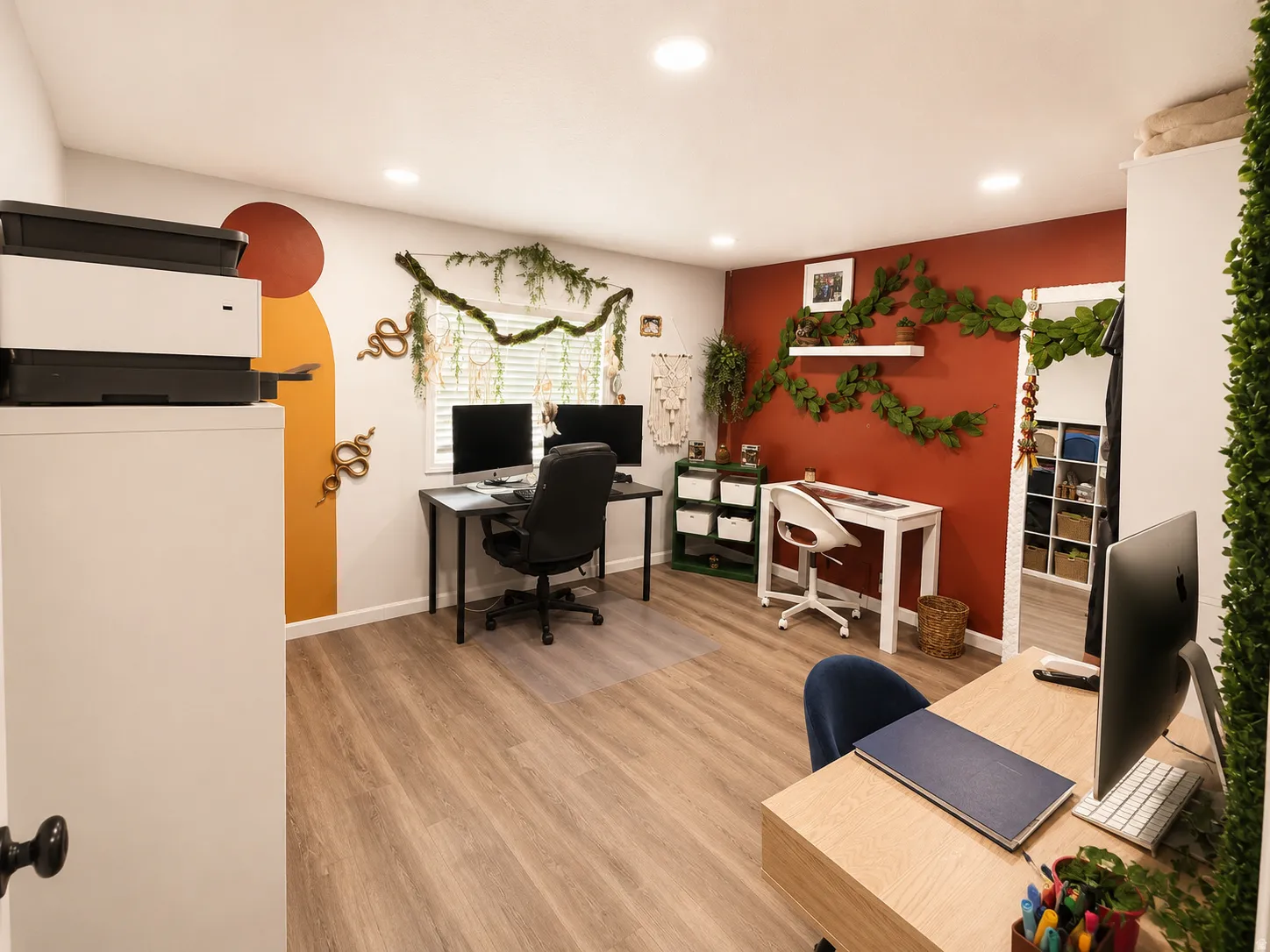 Spacious room featuring wood-finish flooring and recessed lighting