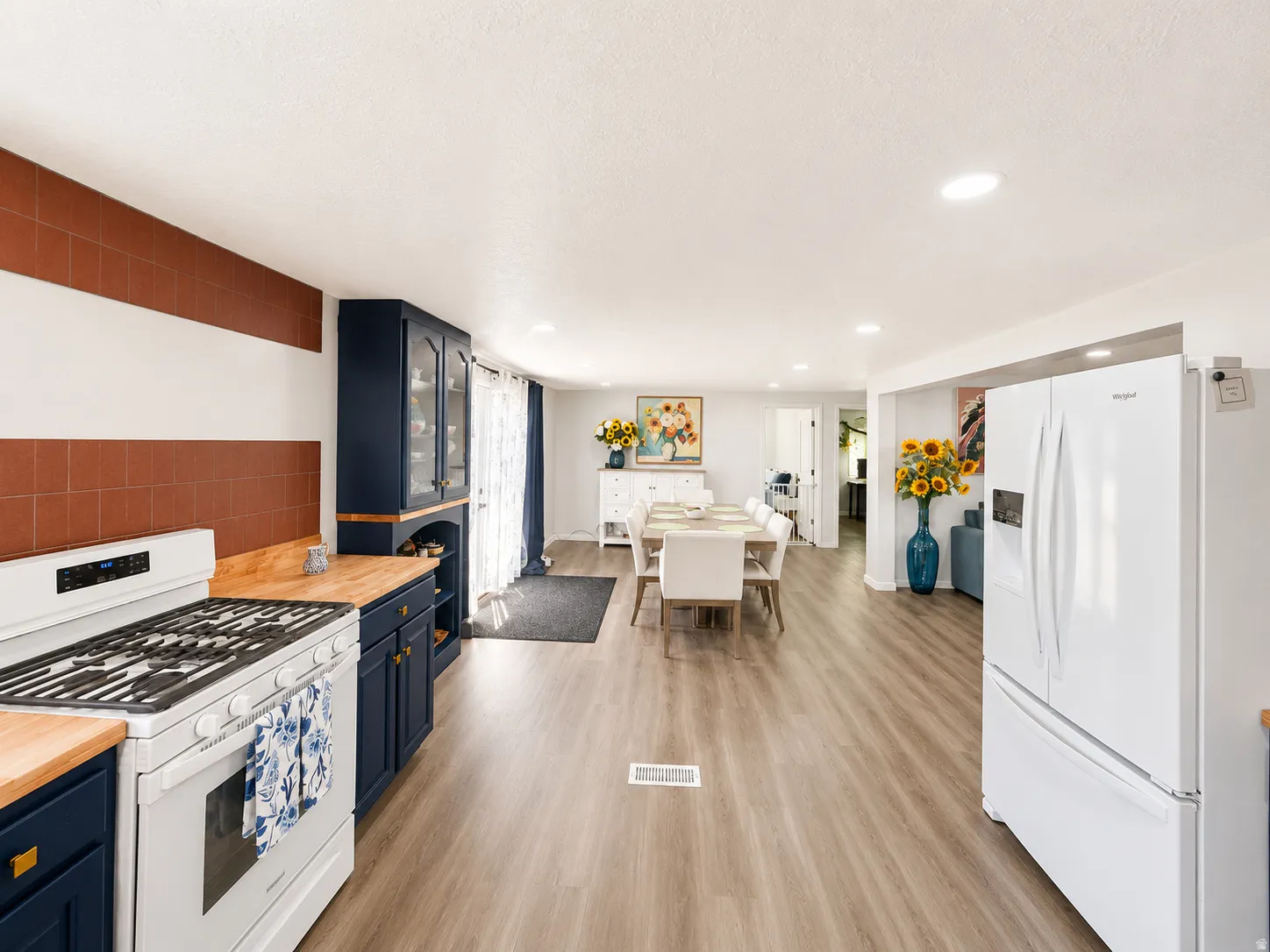 Kitchen and dining area featuring wood-finish flooring