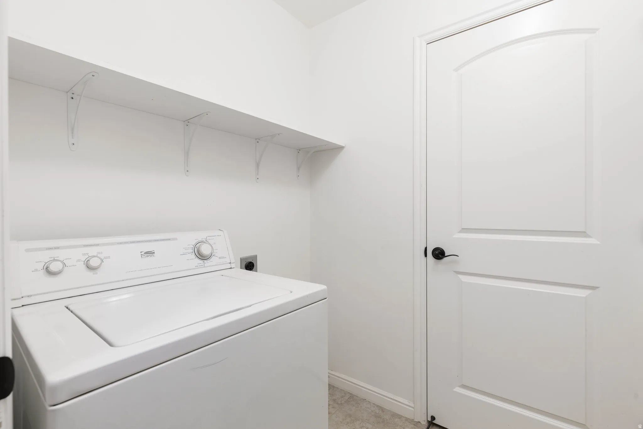 Laundry area featuring washer and storage closet