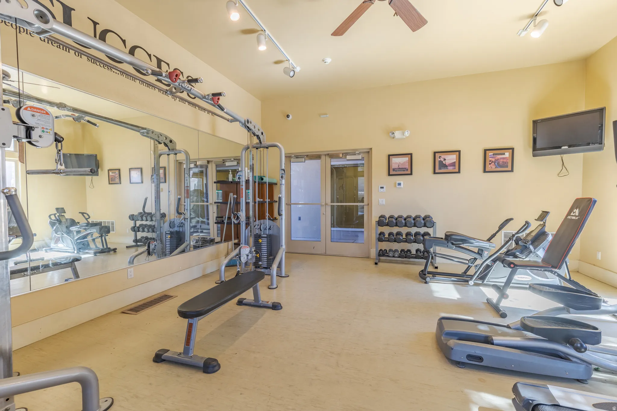 Exercise room with free weights and cardio machines