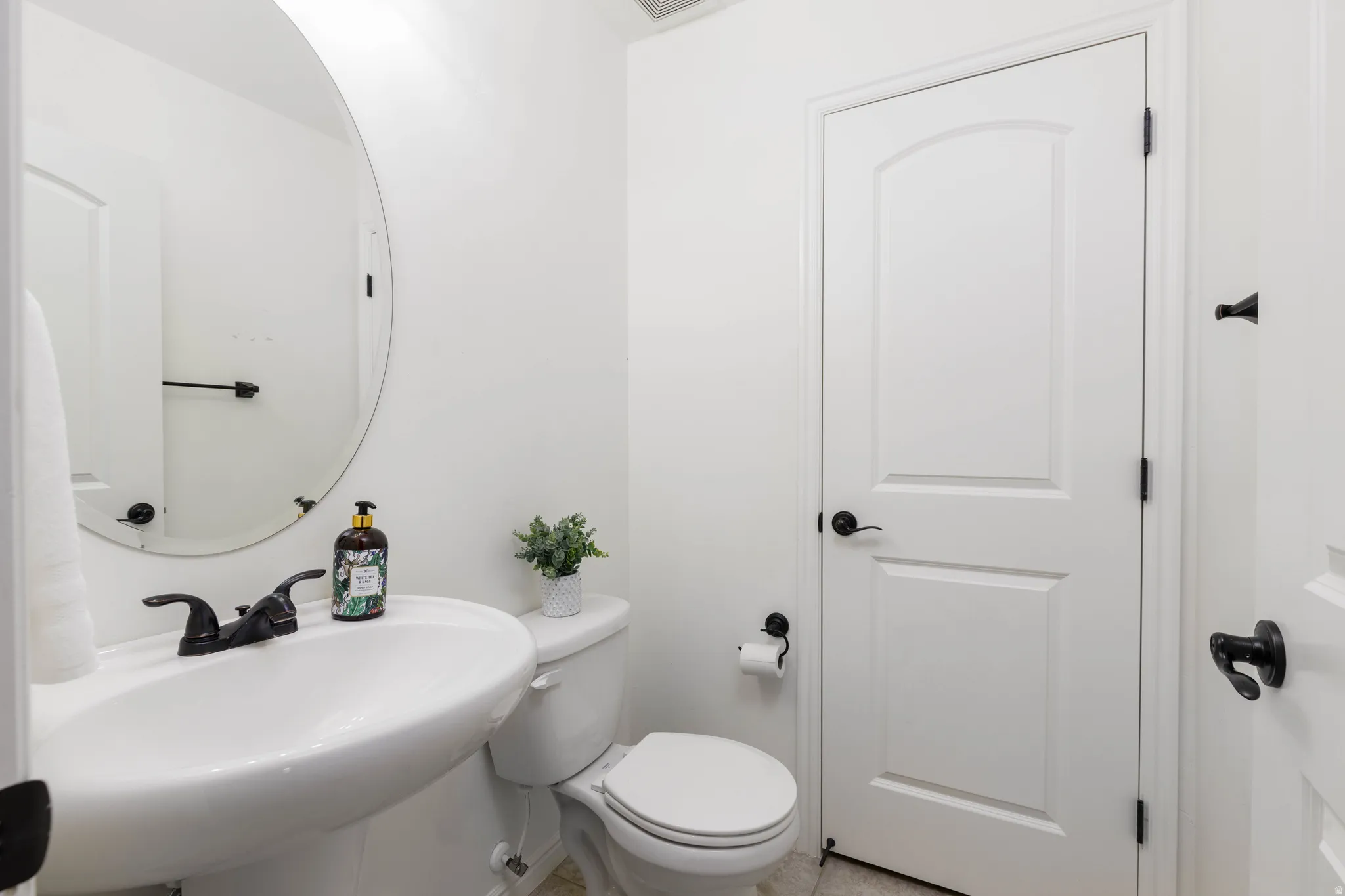 Bathroom with toilet and a pedestal sink