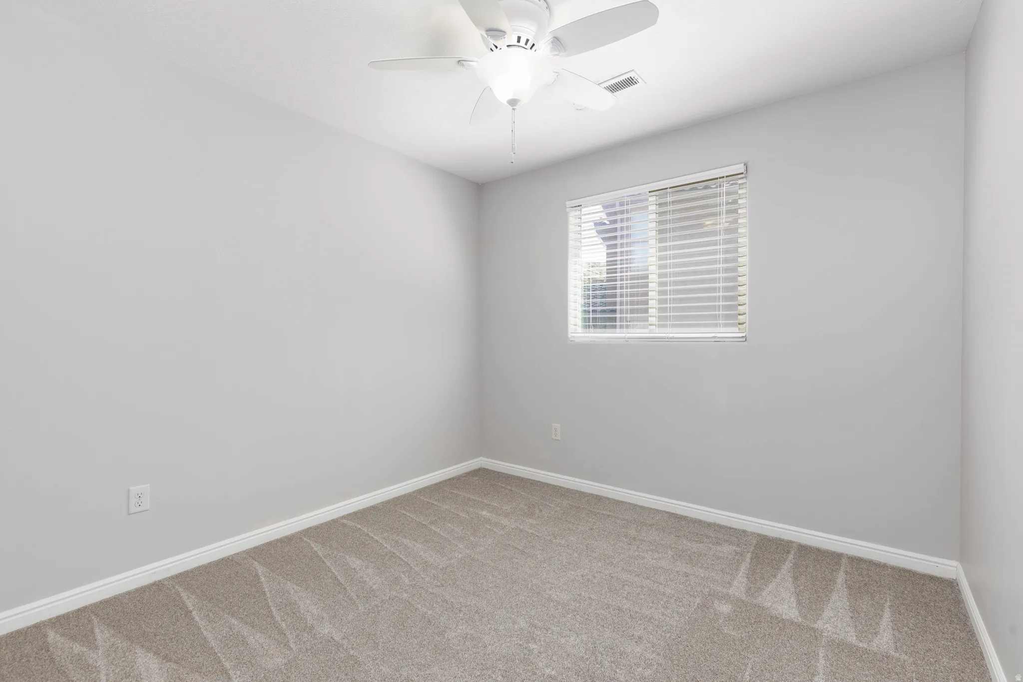 Bedroom 2  with a ceiling fan and light colored carpet