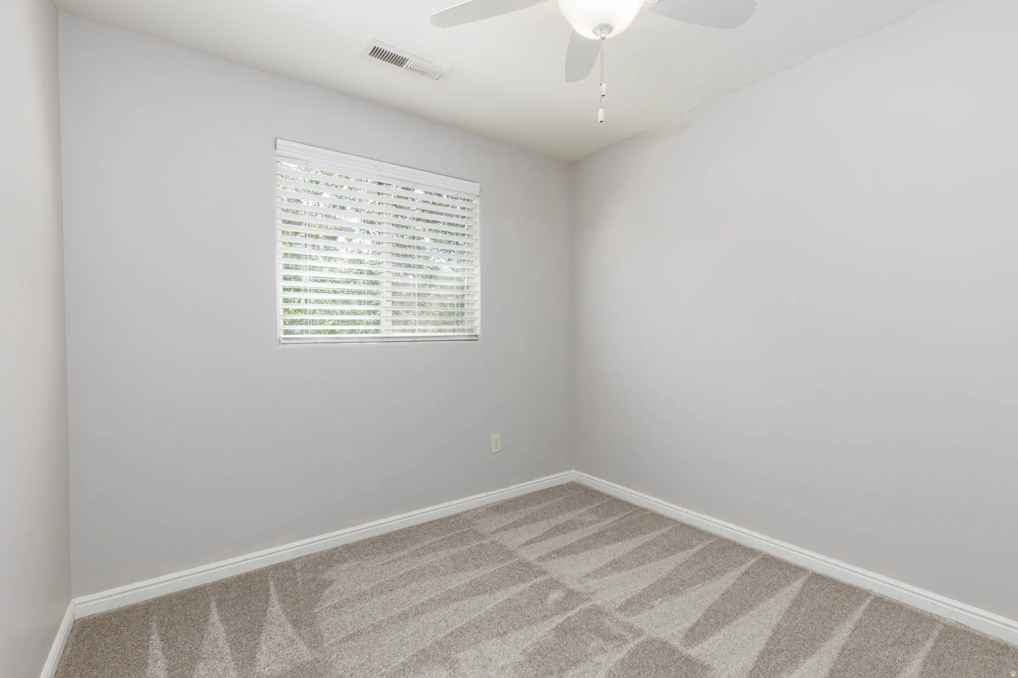 Bedroom 3 with light carpet and ceiling fan