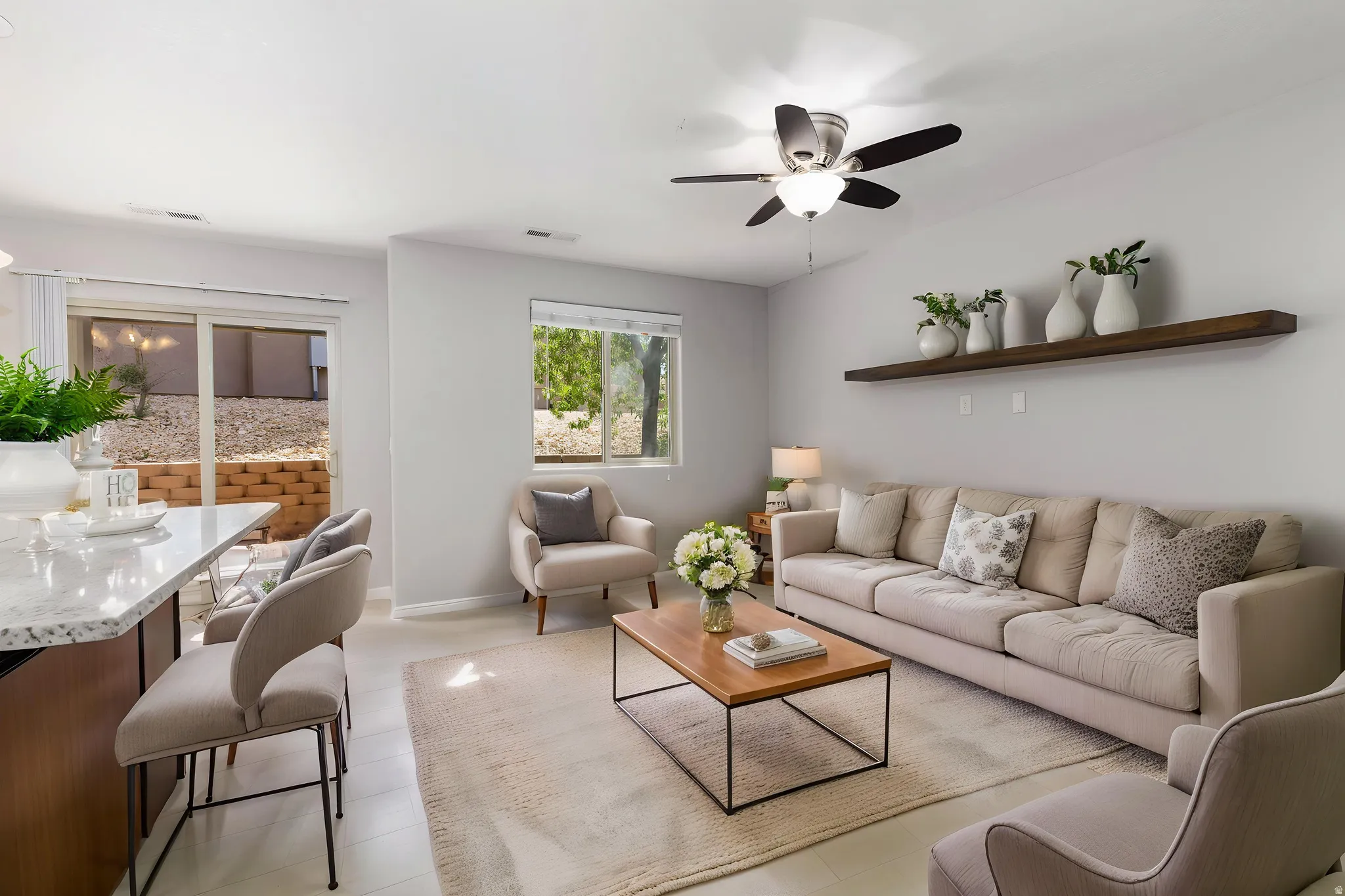 Family room with ceiling fan and carpet, virtual staging