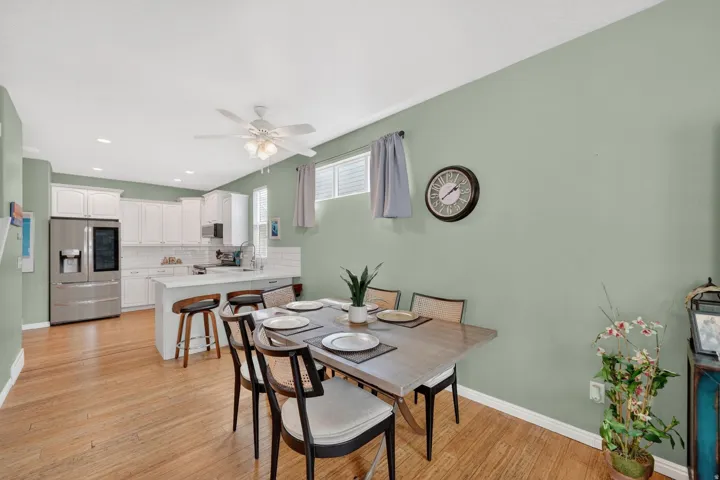 Dining area with light wood-style flooring, ceiling fan, and recessed lighting