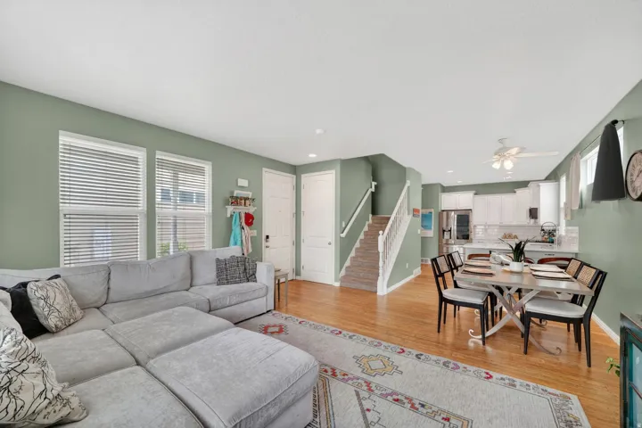 Living room with light wood-style flooring, a ceiling fan, and recessed lighting