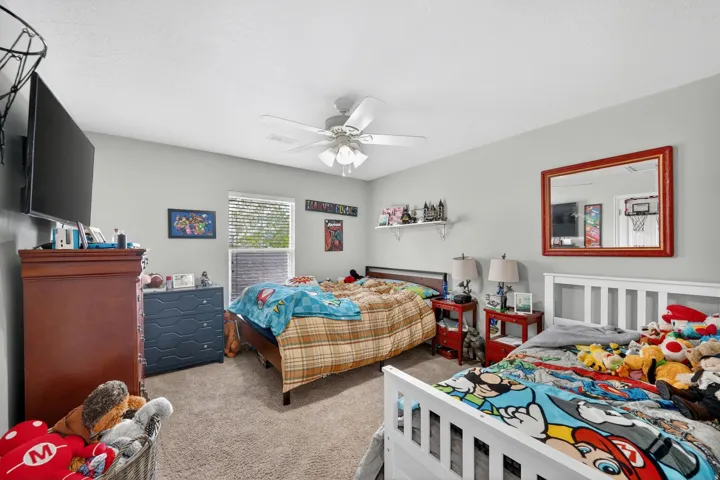 Bedroom with carpet and ceiling fan