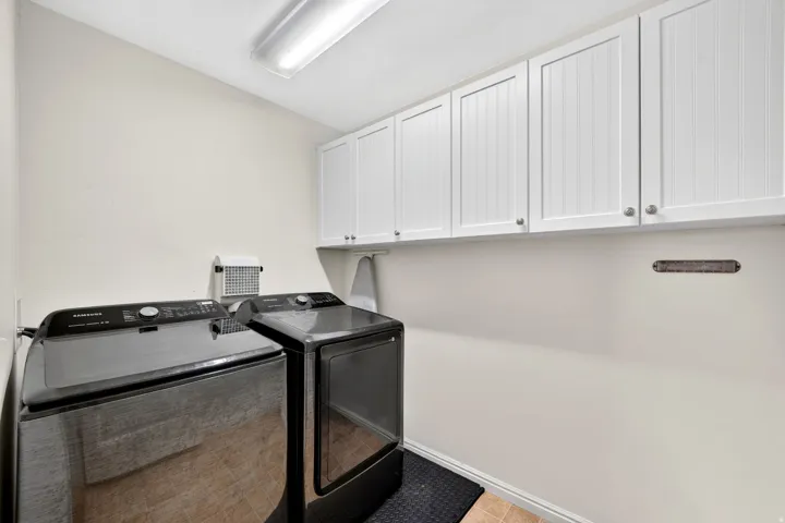 Laundry room with cabinet space and washer and clothes dryer