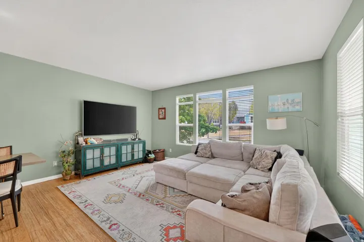 Living room with wood-type flooring and baseboards