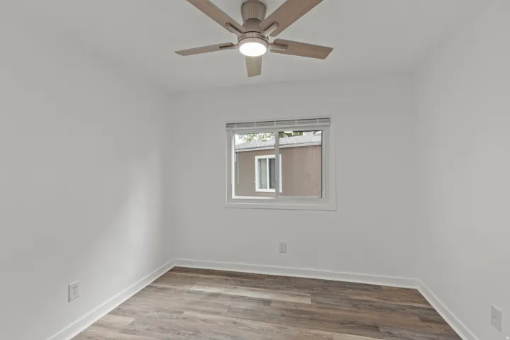Empty room featuring light wood-style flooring and a ceiling fan