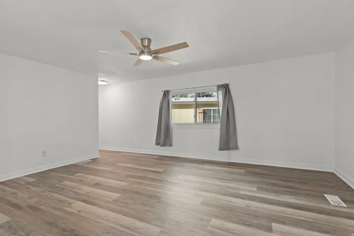 Spare room featuring a ceiling fan and wood finished floors