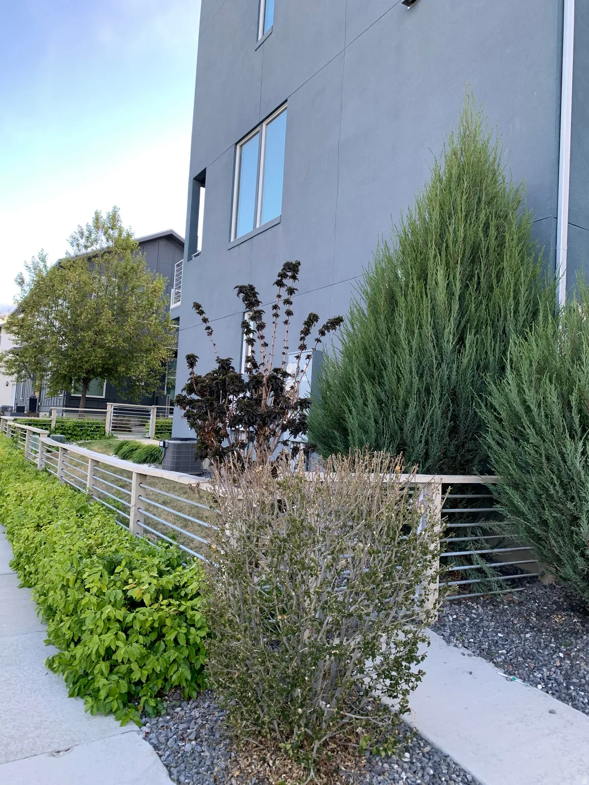 View of side of home with stucco siding and fenced yard