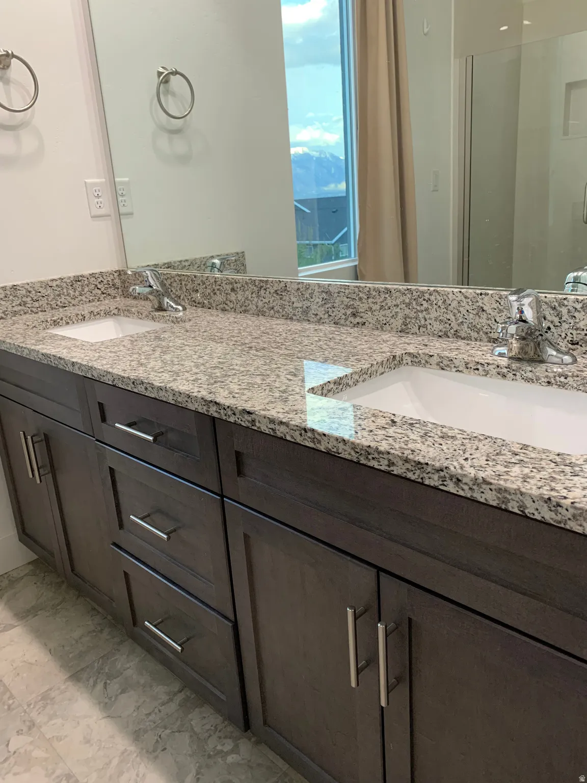 master bath with double vanity and a shower stall