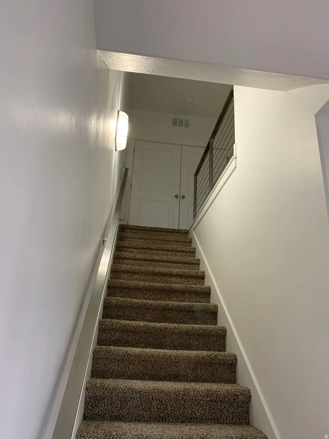 View of staircase, metal & cable railings