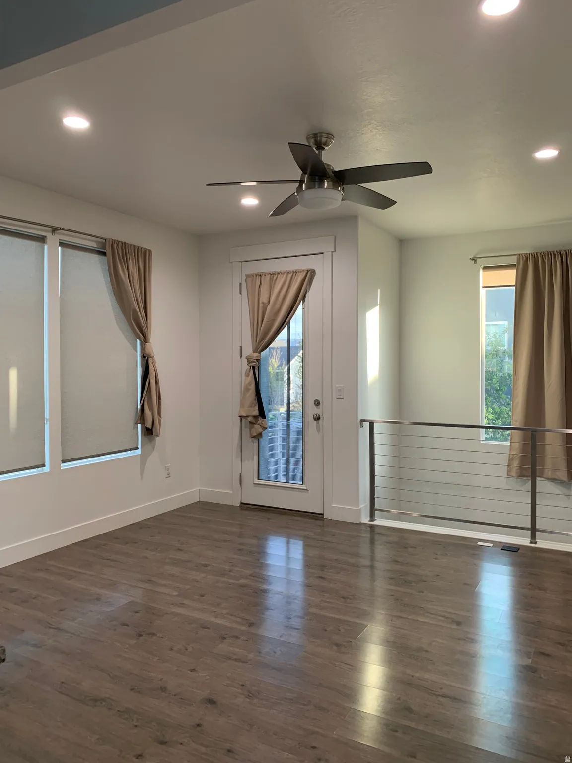 Living room featuring ceiling fan, recessed lighting, and dark wood-like floors